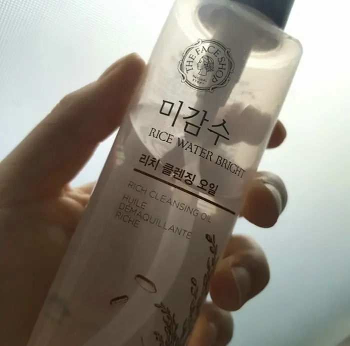 The Face Shop Rice Water Bright Rich Facial Cleansing Oil in hand